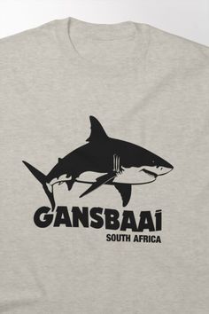 a gray t - shirt with an image of a shark and the words gansbai south africa on it