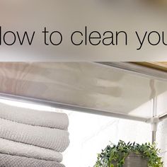 towels stacked on top of each other in front of a sign that says how to clean your closet