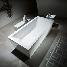 a white bath tub sitting on top of a bathroom floor