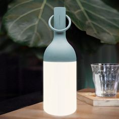 The object of conviviality with its iconic design in the shape of a bottle, designed by Bina Bartel, the ELO lamps will distill a warm atmosphere on your large tables as well as your one-to-one dinners. The removable ring located at the top of each lamp will also allow you to hang your ELO baby on the branch of a tree, a wire, or a hook to illuminate your outdoor spaces. With a powerful light intensity adjustable with the fingertip and an autonomy of up to 40 hours, the ELO lamps are a compendiu Wireless Lamp, Outdoor Table Lamp, Battery Powered Led Lights, Baby Table, Large Tables, Outdoor Table Lamps, Portable Table, Backyard Living, Led Table