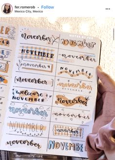 someone is holding up a planner with the words november and november written in different languages