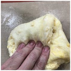 a person is kneading dough with their hands