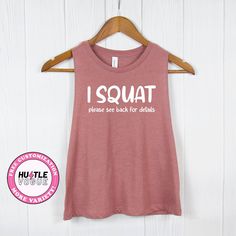 Add a touch of humor to your workout with our Funny Squat Shirt. With the phrase "I Squat," turn around for the amusing details. This funny workout tee is a perfect addition to your workout outfit.  ---------------------------------------------------------- 𝐌𝐨𝐫𝐞 𝐜𝐨𝐥𝐨𝐫 & 𝐒𝐡𝐢𝐫𝐭 𝐨𝐩𝐭𝐢𝐨𝐧𝐬 ➤ https://www.etsy.com/shop/HustleVogue 𝐍𝐎𝐓𝐄: Prior to placing your order, please verify the color availability for each shirt type displayed on the listing image. -------------------------- Sporty T-shirt With Funny Text For Sports, Funny Text Crew Neck Gym Top, Funny Text Crew Neck Top For Gym, Sporty Yoga T-shirt With Letter Print, Short Sleeve Gym Top With Funny Text, Funny Text Short Sleeve Gym Tops, Sporty Tops With Funny Text For Workout, Sporty Workout Tops With Funny Text, Funny Gym Tops With Crew Neck