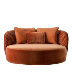 a round couch with two pillows on it