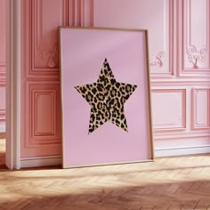 a pink room with a leopard print star on the wall and wood flooring in front of it