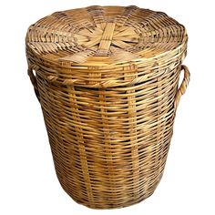 a large wicker basket with handles on an isolated white background