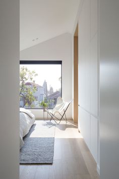 a bedroom with a large window overlooking the city