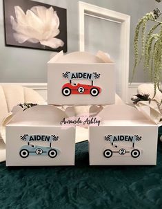 three personalized boxes with race cars on them