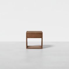 a small wooden table sitting on top of a white floor