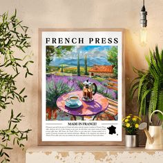 a french press coffee poster hangs on the wall next to a potted plant and watering can