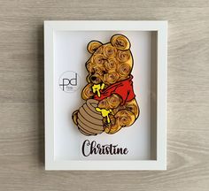 a white frame holding a teddy bear with roses in it