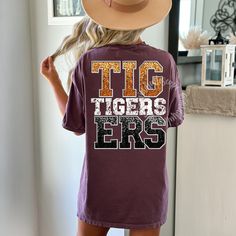 a woman wearing a t - shirt that says tig tigers ers on it