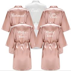 six bridesmaid robes in pink and white with the words maid of honor written on them