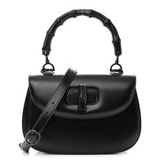 This is an authentic GUCCI Boarded Dyana Lux Calfskin Web Monochrome Medium Bamboo 1947 Top Handle Bag in Black. This chic bag is crafted of calfskin leather in black. The bag has a sturdy looping black bamboo top handle, a leather shoulder strap, black hardware, and a bamboo turn lock on the front. This opens to a black leather interior with zipper and patch pockets. Gucci Bamboo 1947, Gucci Bamboo Bag, Fake Designer Bags, Gucci Crossbody Bag, Bamboo Top, Bamboo Bag, Gucci Crossbody, Black Bamboo, Gucci Monogram