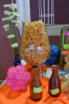 the table is covered with different types of pasta and wine glasses, flowers, and other items