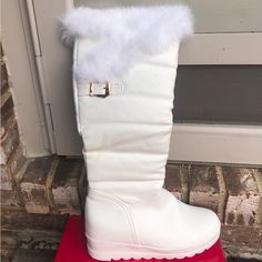 Brand New - Never Worn. Pure-White Faux Leather Detailed With Horizontal, Pleated Contrast Stitching. Trimmed In Light, Fluffy Feather/Down. Height: 17” Tall / Wedged Heel 2” High. Rubber Sole. Decorated With A Pretty Gold Buckle! Soft, Thin, Cream-Colored Inside Lining. Boots Come In Their Original Hot-Pink Hinged Shoe Box And With Soft, Protective Shoe Bags. Trendy, Unique, And Beautiful! Wedged Heel, Bags Trendy, Shoe Bags, Forever Young, Winter White, Winter Rain, Pure White, Shoe Box, Cream Color