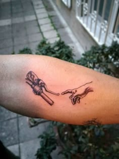 a tattoo on the arm of a man with two hands holding each other