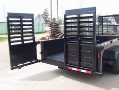 a black trailer is parked on the street