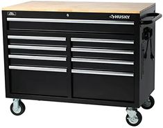 the husky tool cabinet is on wheels and has two drawers, one with three drawers