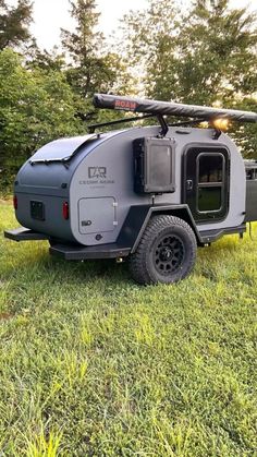 an off road camper trailer parked in the grass