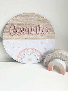 a wooden sign that says be mine next to a pair of toys on a shelf