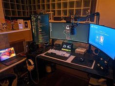 a computer desk with two monitors and a keyboard