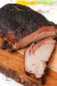 a large piece of meat sitting on top of a wooden cutting board