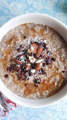 a bowl filled with oatmeal and nuts on top of a table cloth