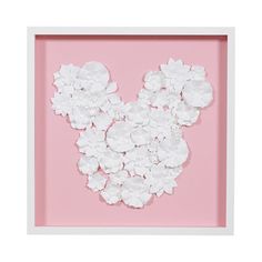 a pink frame with white flowers in the shape of mickey mouse's head on it