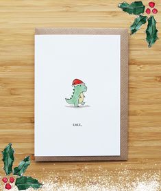 a christmas card with a green dinosaur wearing a santa hat and holly leaves on it