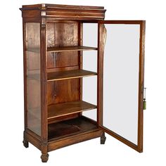 an antique wooden bookcase with glass doors and mirror on the bottom shelf, in front of a white background