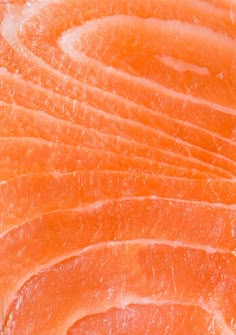 an orange fish fillet is shown in this close up photo with the skin visible