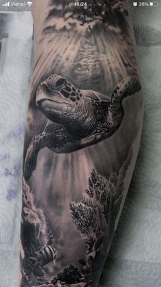 a man with a tattoo on his arm that has a turtle swimming in the water