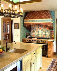 a kitchen with an island, stove and sink in the center is decorated with colorful tiles