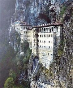 an old castle built into the side of a mountain