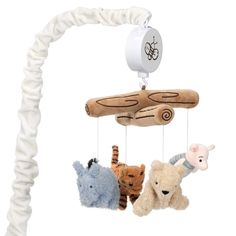 three stuffed animals hanging from a wooden mobile