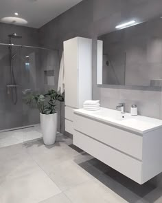 a modern bathroom with grey walls and white fixtures