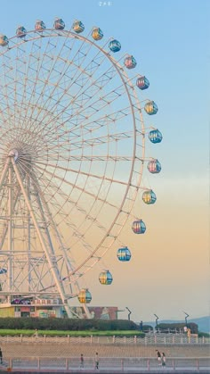 a large ferris wheel sitting on top of a beach