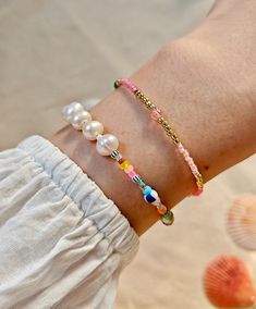 ✋100% HANDMADE A set of colorful, cheerful bracelets to compliment any outfit! 📏SIZE: Style A : 17cm long / 6.7 inch Style B : 17cm long / 6.7 inch * If you need other lengths, please contact me or leave a message in the order. 📿 MATERIAL: 6-7mm freshwater pearl 2-5mm glass beads 4-5mm natural stone 18K Gold plated clasp 📦 Packaging: 🔆 All comes in a beautifully packaged cotton pouch ready to be gifted. * If you have any ideas about packaging, please feel free to contact me. ✈️ Shipping and Delivery: 🔆 I fully understand your concerns about international shipping, so I improve the logistics experience in every link: * All items ship within 1-2 business days (3-4 days for custom orders). * All orders have tracking so you can monitor the delivery process. * It takes about 8-10 business Tiny Bead Bracelet, Summer Beach Jewelry, Cotton Pouch, Bracelet Pearl, Seed Bead Bracelet, Gold Bead Bracelets, Stackable Bracelets, Seed Bead Bracelets, Bracelet For Women