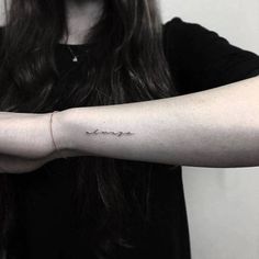 a woman's arm with the word love tattooed on her left forearm and wrist