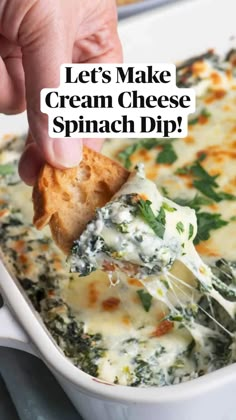 a hand dipping a piece of bread into a casserole dish with spinach dip