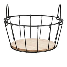 a black wire basket with a wooden board in it