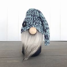 an old man's hat and beard on top of a wooden table