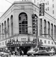 an old black and white photo of people standing in front of a building with the words roos - atkin's on it