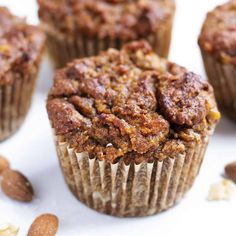 several muffins with nuts scattered around them