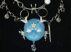 a blue necklace with silver chains and charms