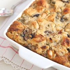 a casserole dish with bread and raisins in it