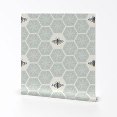 a wallpaper with a pattern of bees on the front and back of it, against a white background