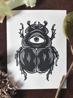 a black and white drawing of a beetle with an all seeing eye on it's back