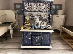 an old china cabinet is decorated with blue and white dishes